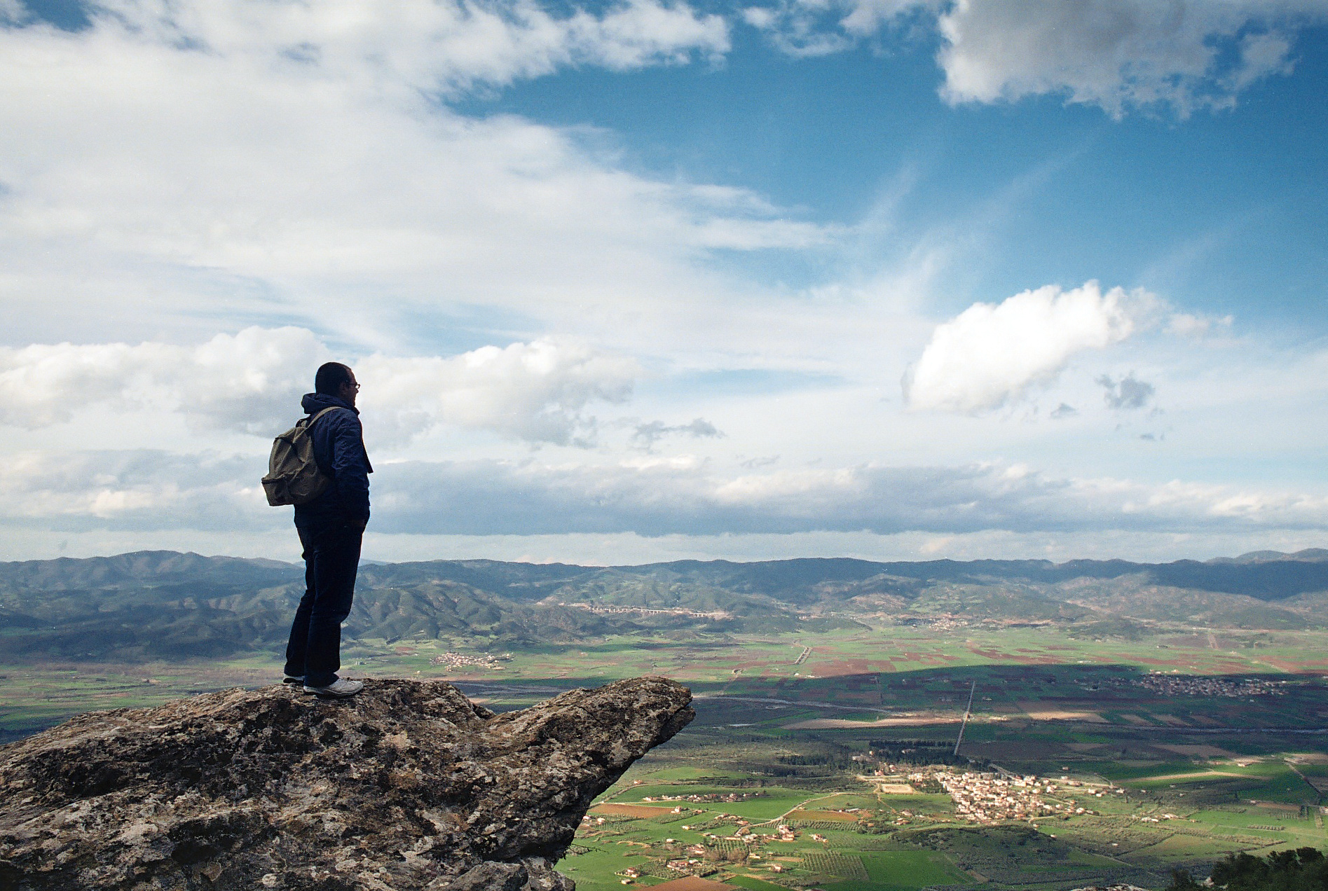 A seasoned trail guide leading travelers on a mountain path